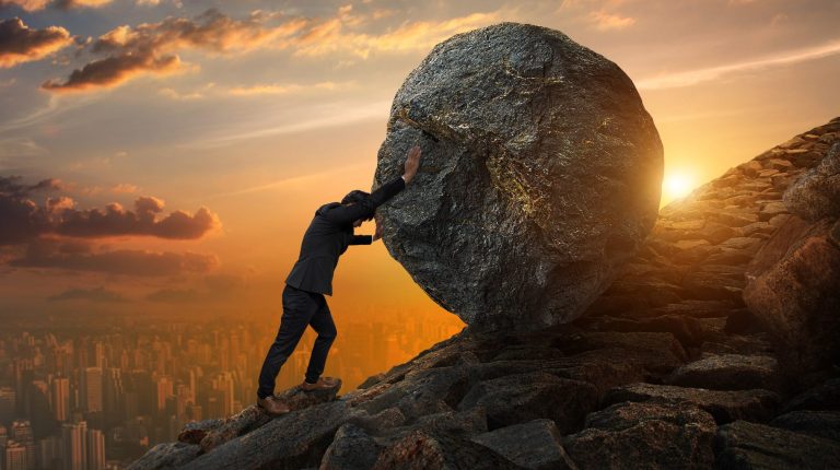 Man pushing bolder uphill