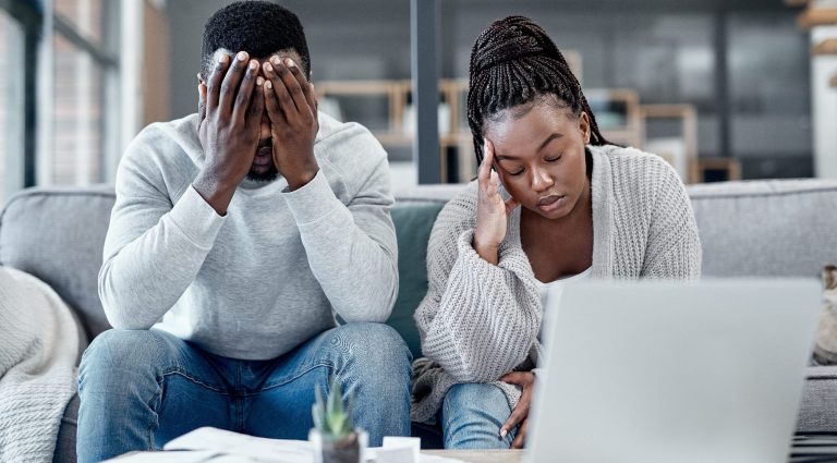 Couple on sofa stressed